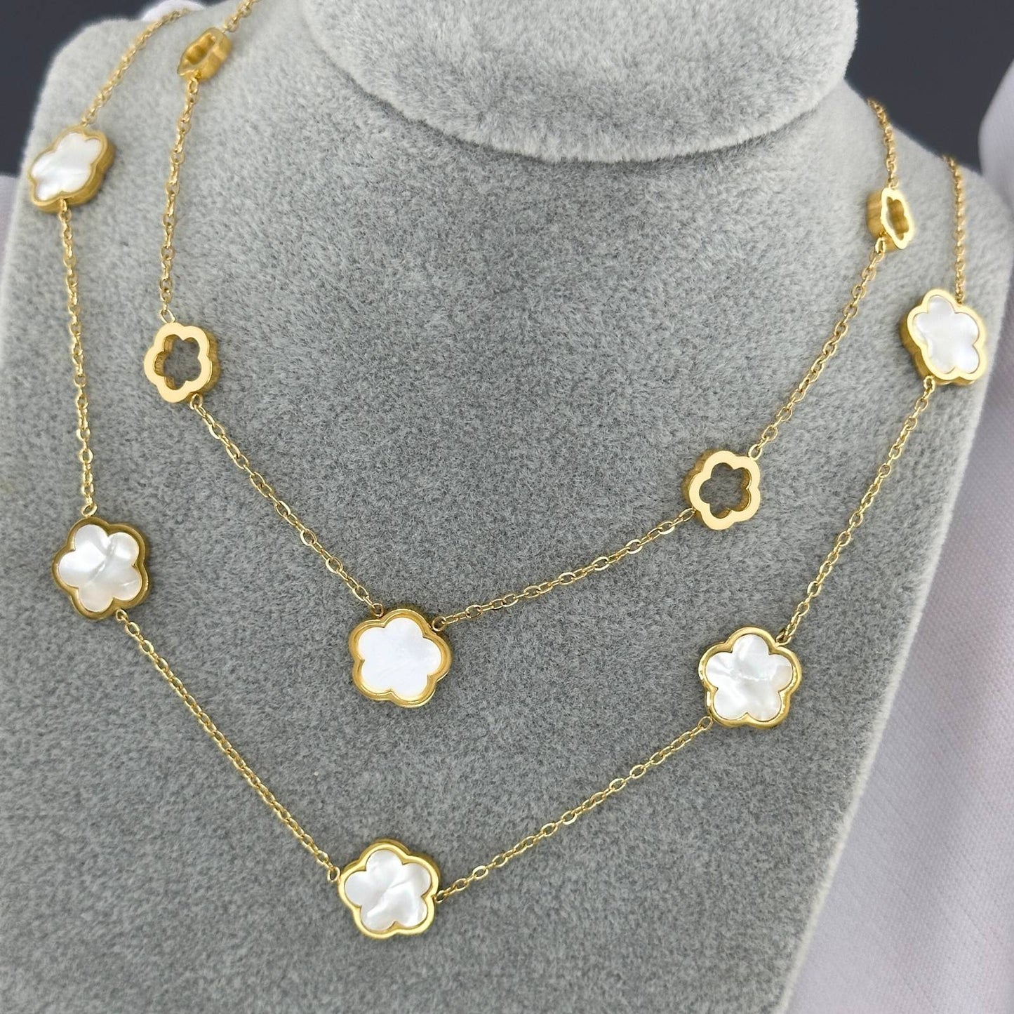 gold dainty necklace with white flower