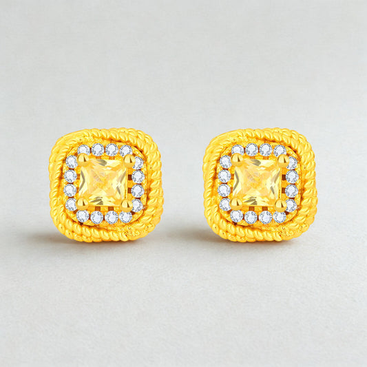 Pair of yellow square earrings with clear gemstones on a light gray background
