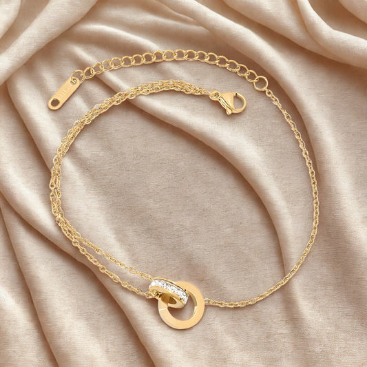 Gold bracelet with double ring circle and roman numerals with cubic zirconia