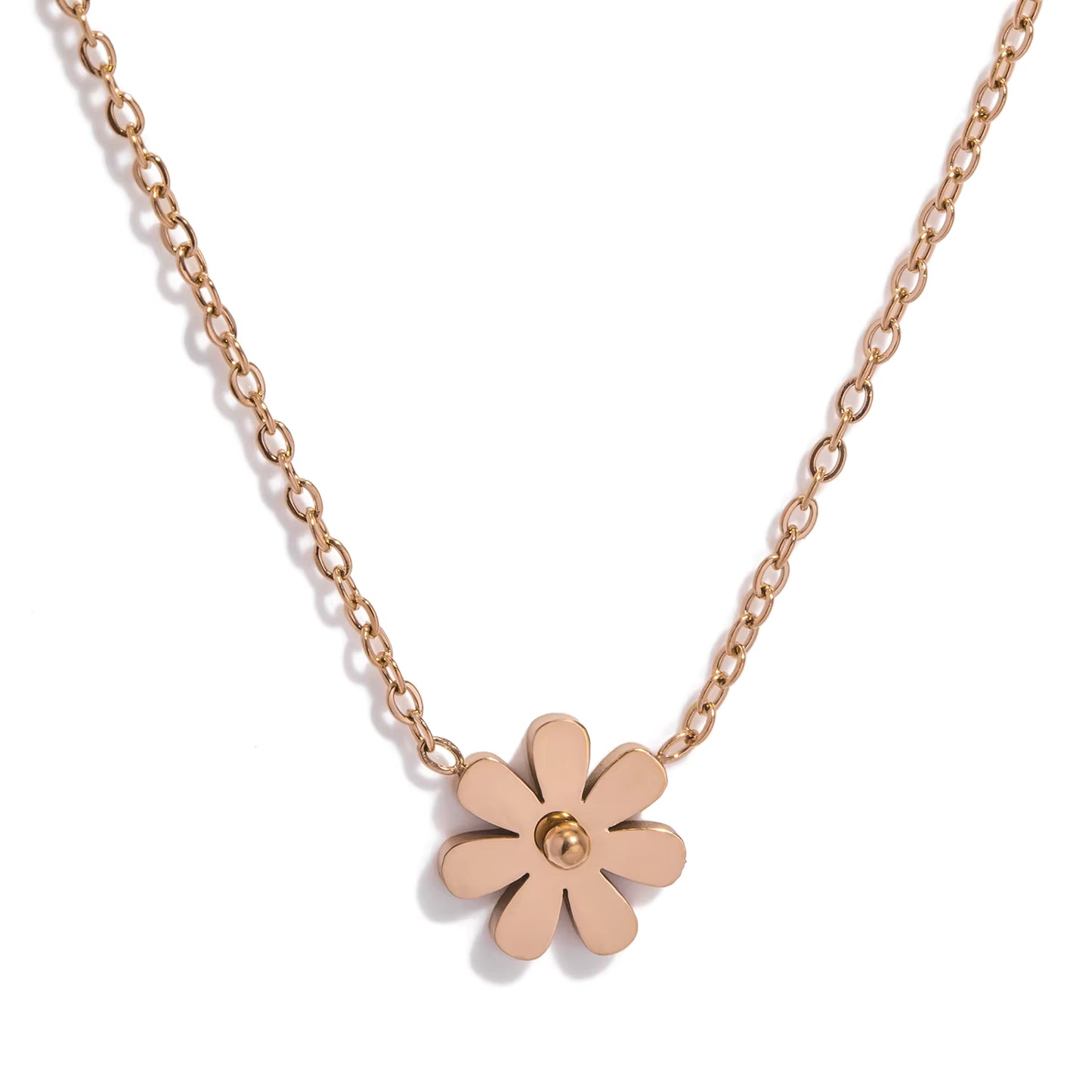 Rose gold flower-shaped pendant on a chain against a white background