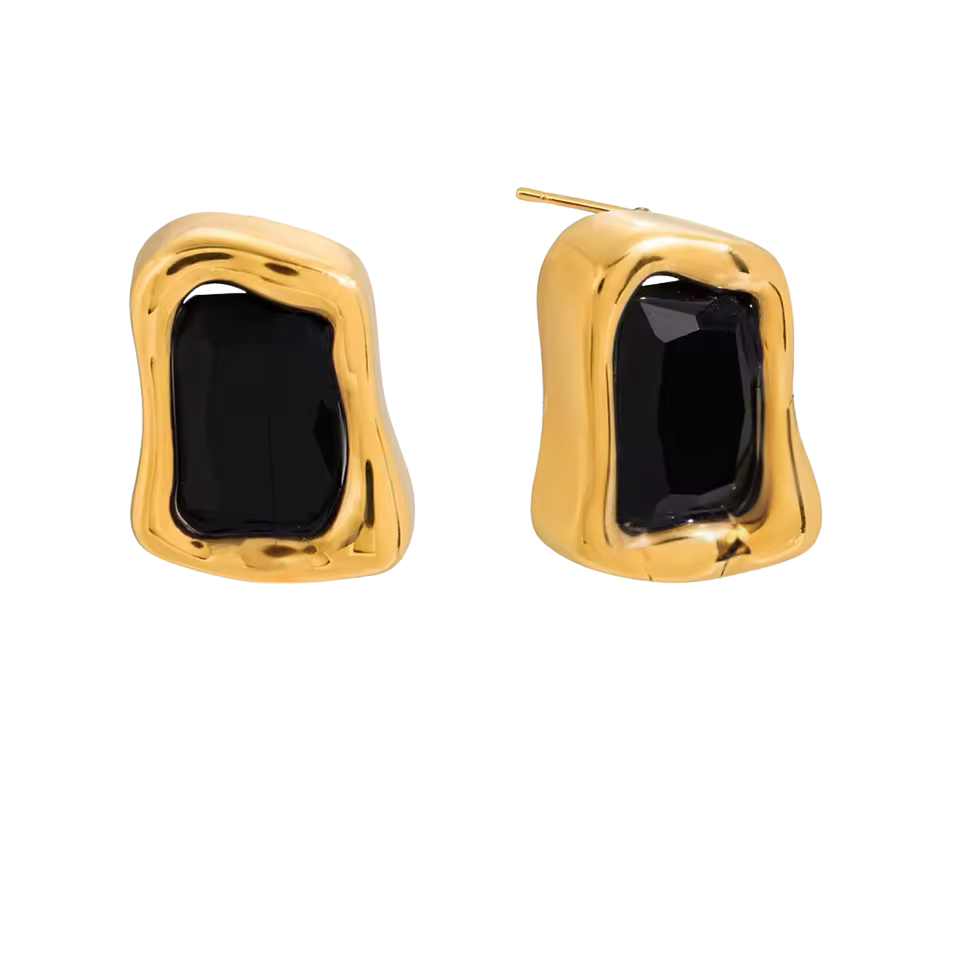 Gold earrings with black stones on a white background
