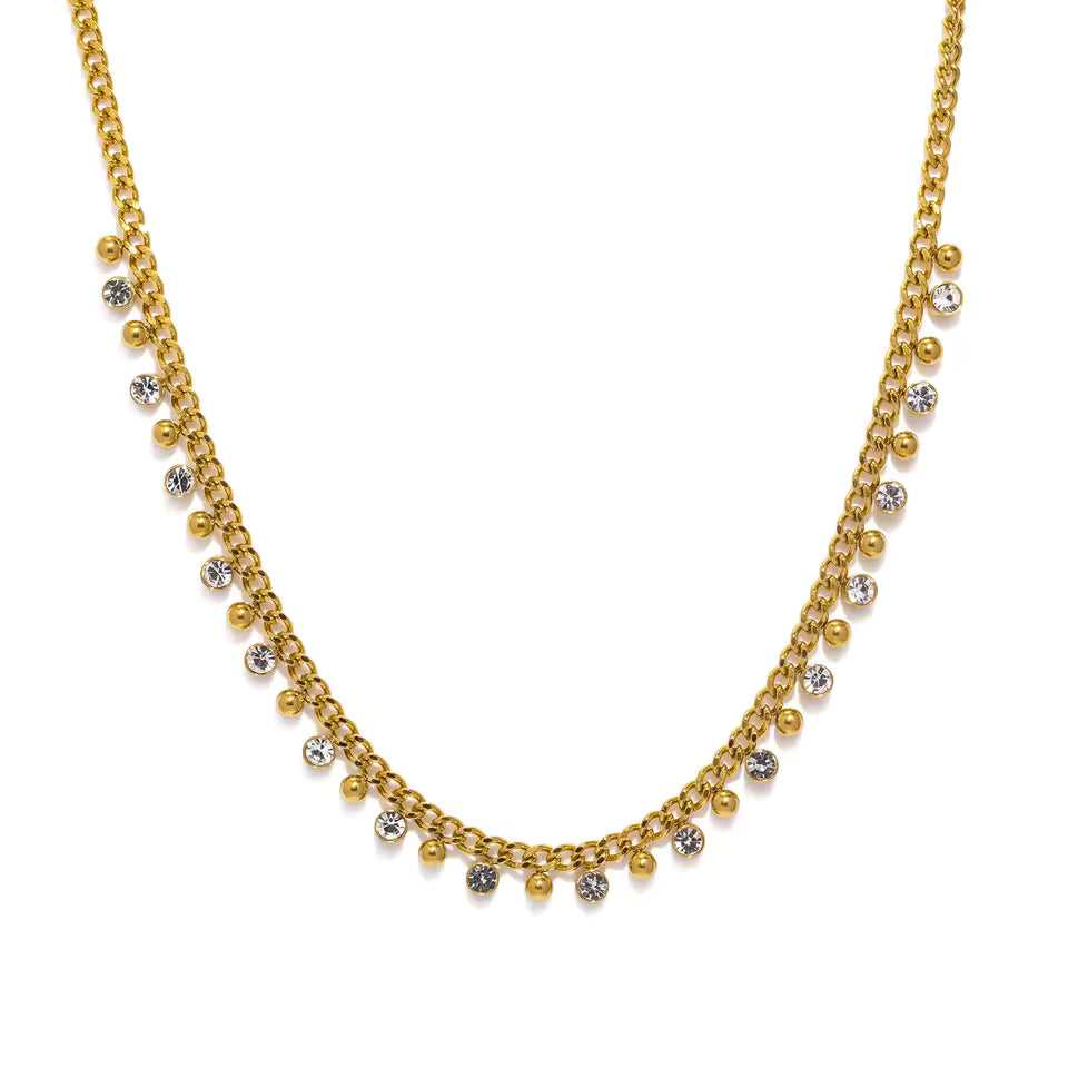 Gold necklace with small round beads on a white background