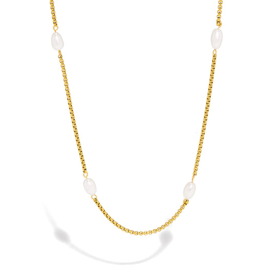 Gold necklace with white pearls on a white background
