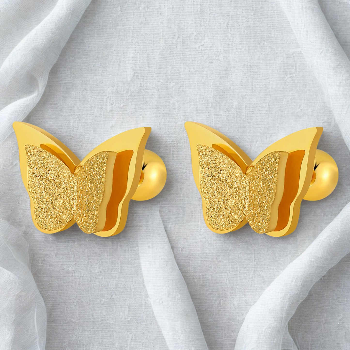 Gold butterfly stud earrings with textured wing detail.