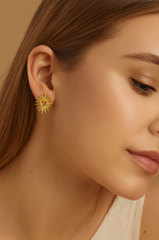 Close-up of a woman wearing a gold earring with a heart design.