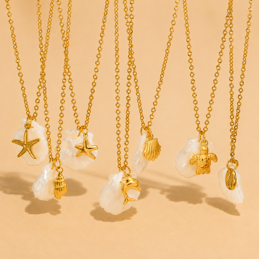 Gold necklaces with various pendants on a beige background