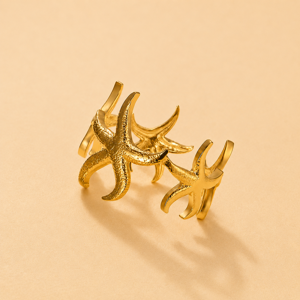 Gold adjustable starfish ring with textured ocean-inspired detailing, perfect for beach lovers, coastal jewelry collections, and summer fashion styling.