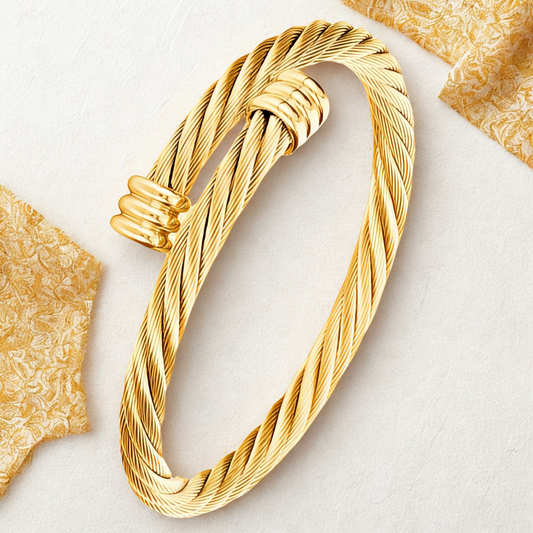 Gold rope-style bracelet with a wrapped strand detail, displayed flat