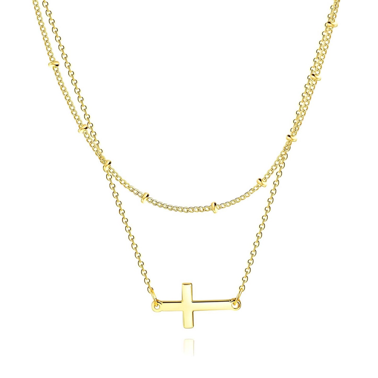 Gold layered necklace with sideways cross pendant, minimalist Christian jewelry.

