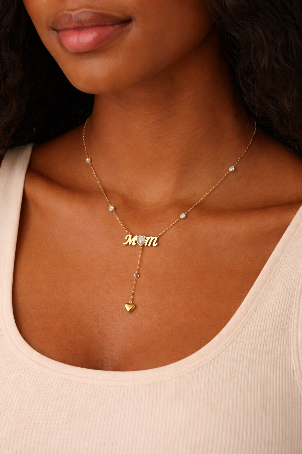 Necklace with 'Mom' pendant worn by a person
