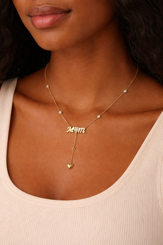Necklace with 'Mom' pendant worn by a person