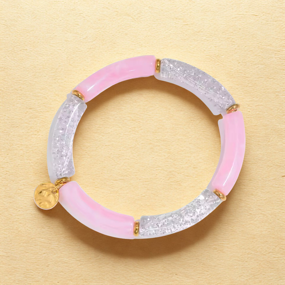 Bracelet with pink and silver sections on a beige background