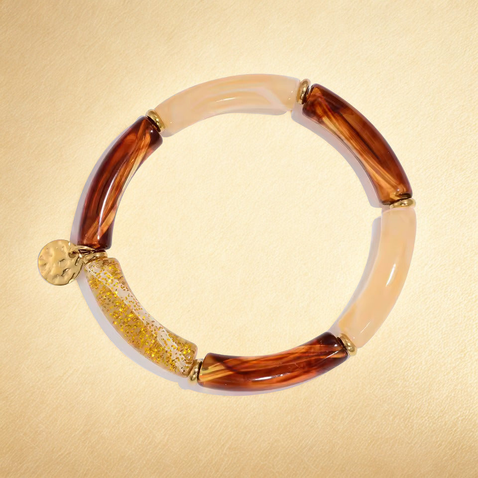 Bracelet with brown and beige beads on a beige background