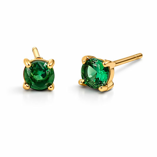 Gold stud earrings with green gemstones on a white background