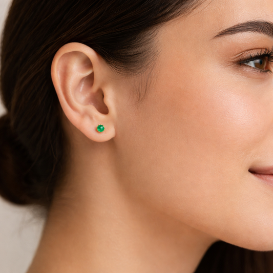 Close-up of a woman wearing a green earring.