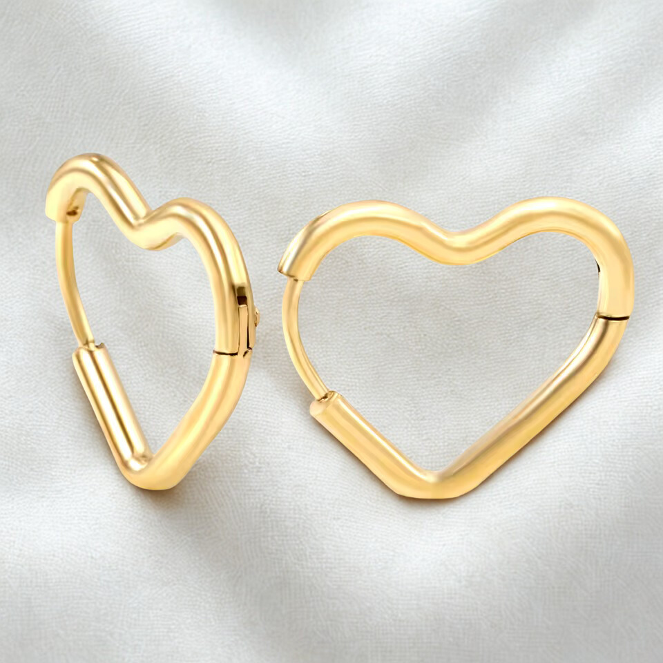 Gold heart-shaped hoop earrings on a light gray background