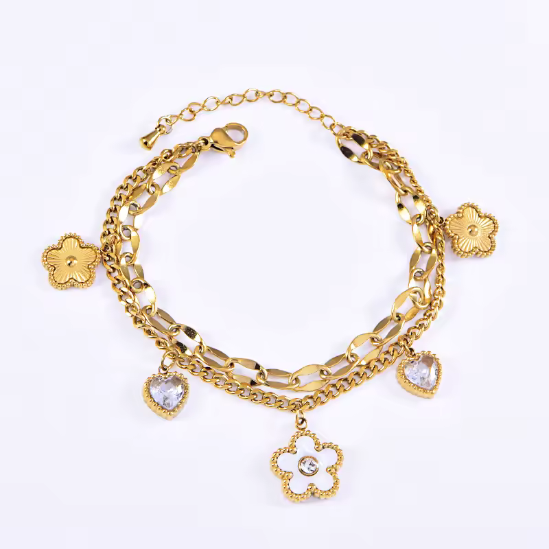 Gold bracelet with charms on a white background