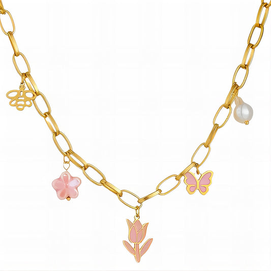 Gold charm necklace with flower, butterfly, and pearl charms on elongated link chain