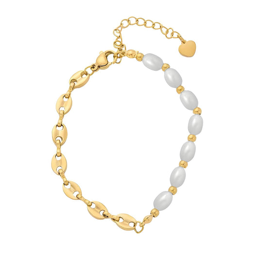 Delicate gold and pearl bracelet styled on wrist with soft lighting