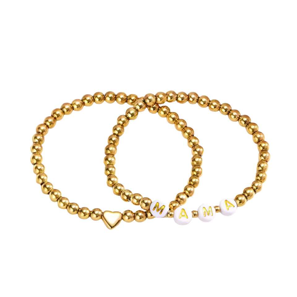A sweet pairing of two stretch bracelets: one with a polished gold heart, the other spelling out MAMA in soft white beads. This set is lightweight, meaningful, and perfect for everyday wear. A simple way to honor the love that beats at the center of motherhood.