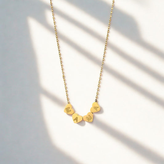 Gold mama necklace with heart-shaped letters on a delicate chain