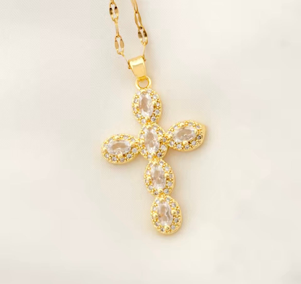 Gold cross necklace with oval clear stones