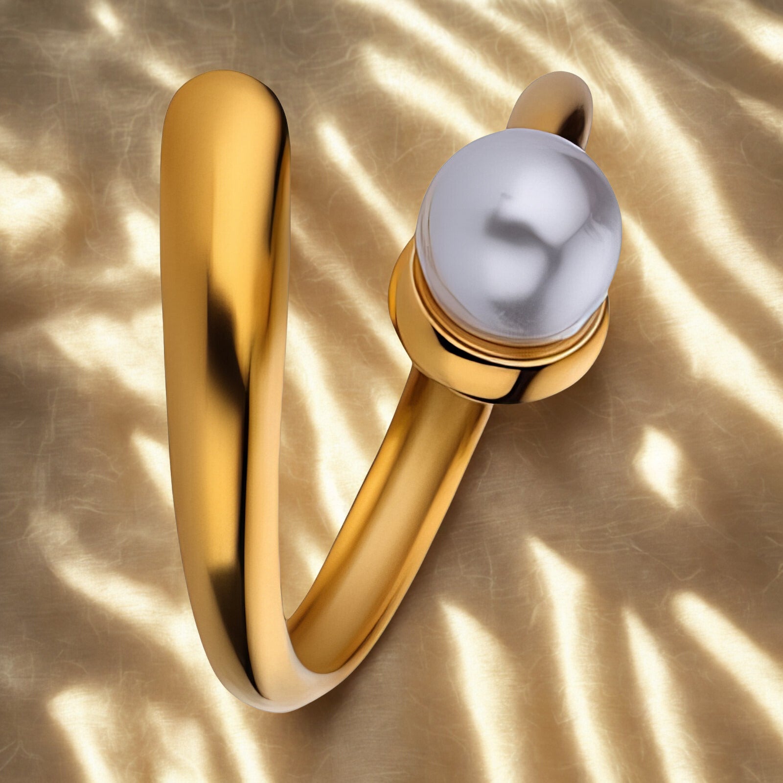 Gold ring with a pearl on a gold background