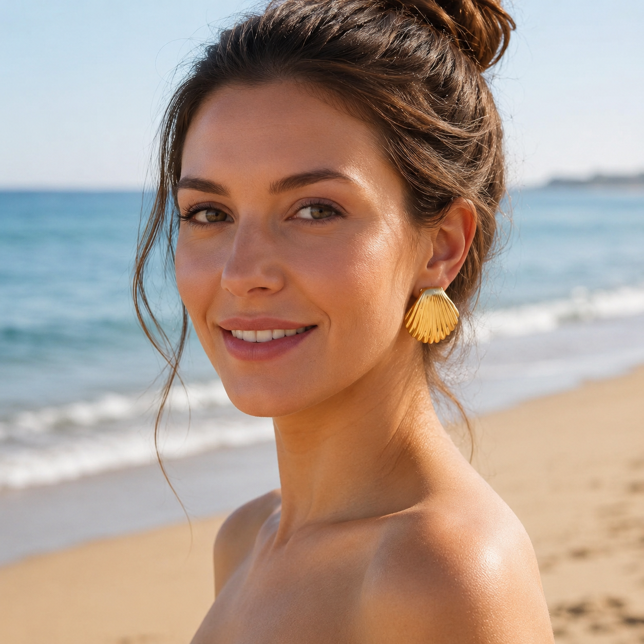 Woman with shell earrings on a beach