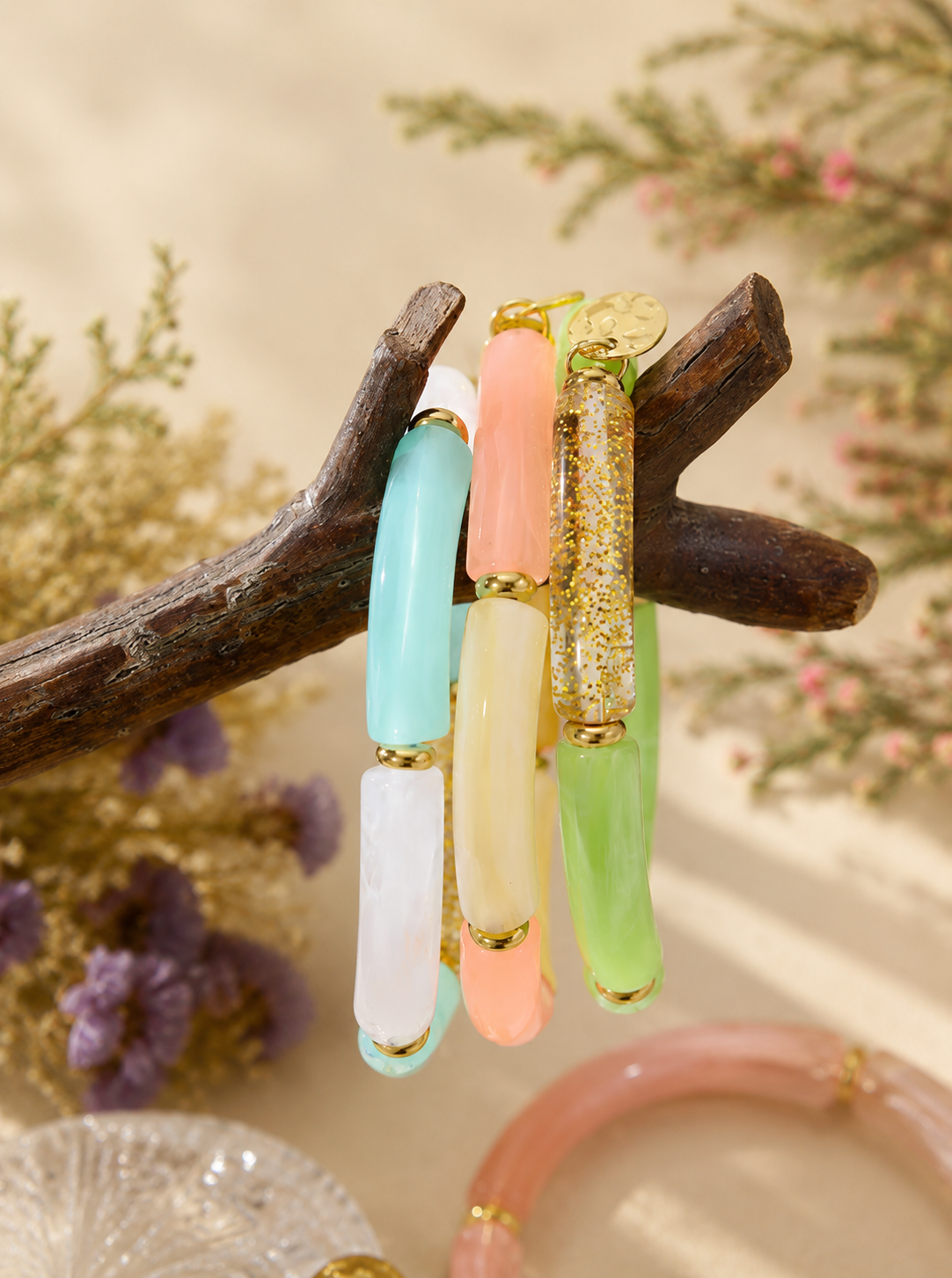 Blue, coral and green jade acrylic bracelets on a branch