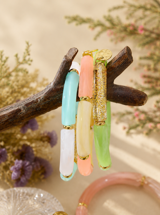 Blue, coral and green jade acrylic bracelets on a branch