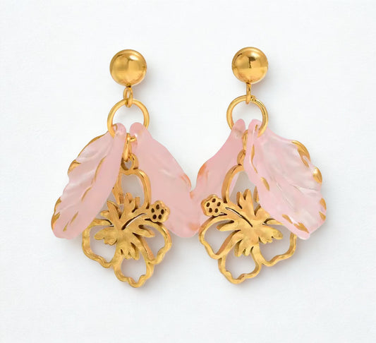 Pair of earrings with pink floral designs and gold accents.Pink flower statement earrings with gold accents and tropical floral design.