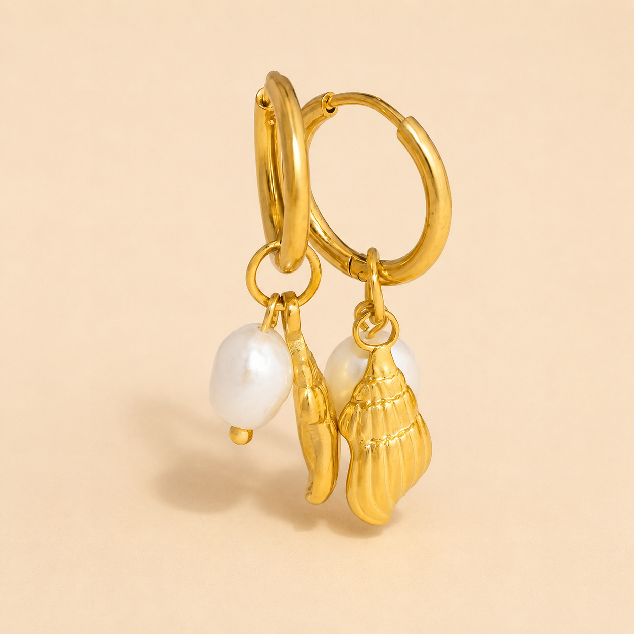 Gold hoop earrings with pearl accents and conch shell charms