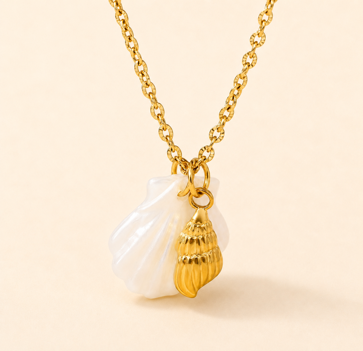 Gold necklace with a shell pendant on a beige background