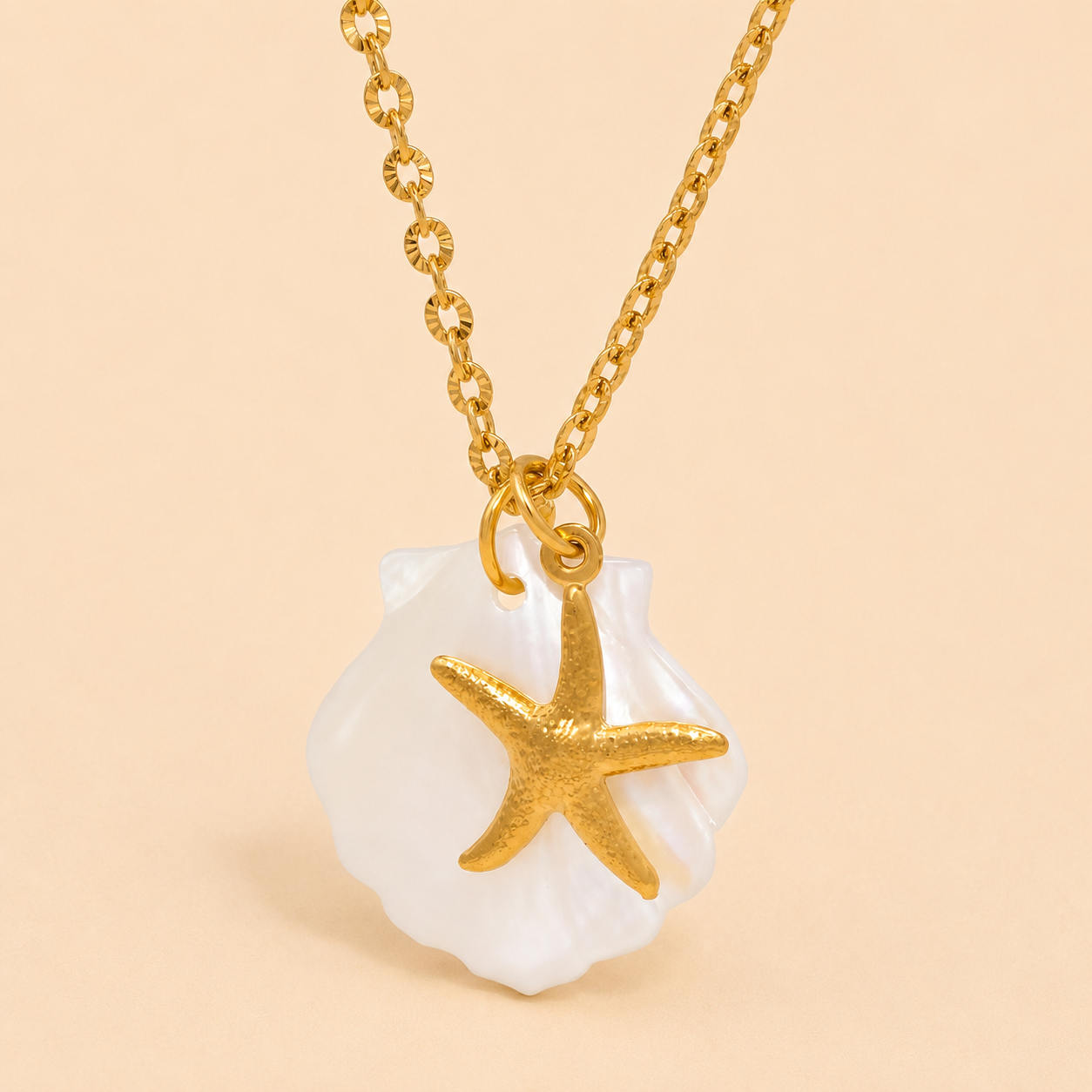 Gold necklace with a starfish pendant on a beige background