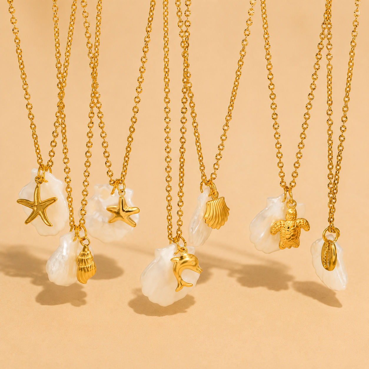 Gold necklaces with various pendants on a beige background