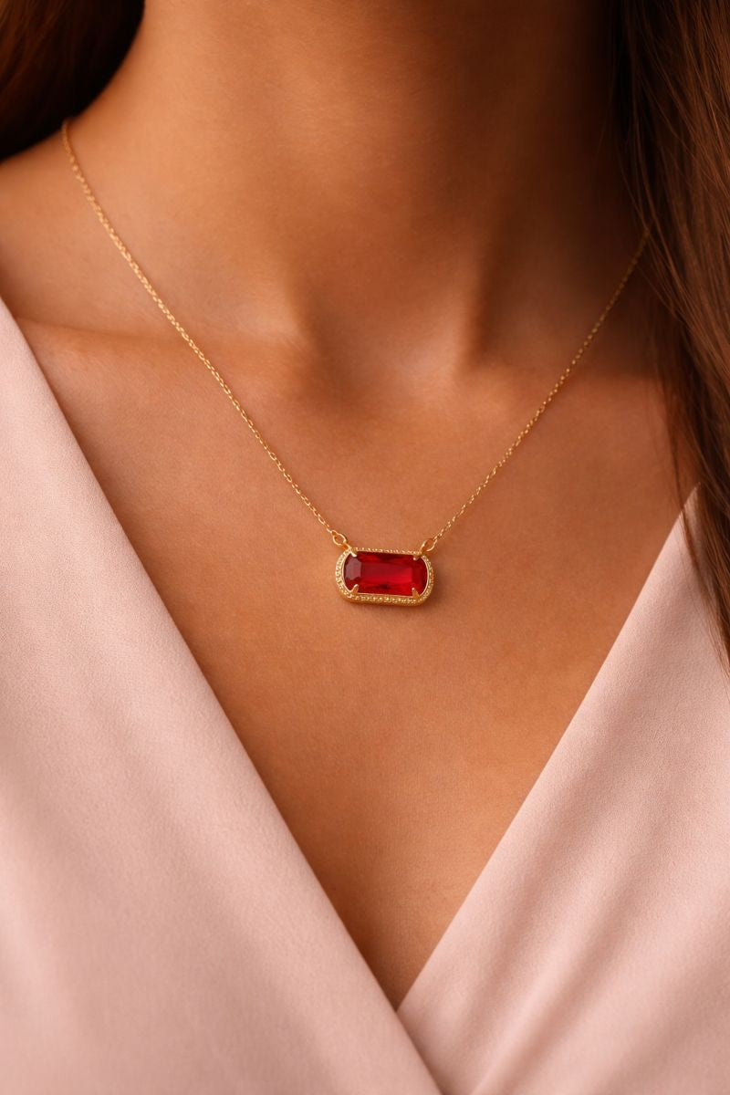 Gold rectangular gemstone necklace with red stone pendant on a delicate gold chain – Resolve Necklace.