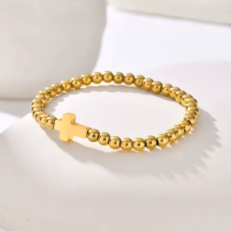Rooted Bracelet – gold beaded stretch bracelet with minimalist cross charm