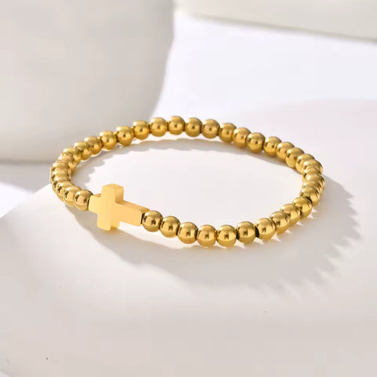Rooted Bracelet – gold beaded stretch bracelet with minimalist cross charm