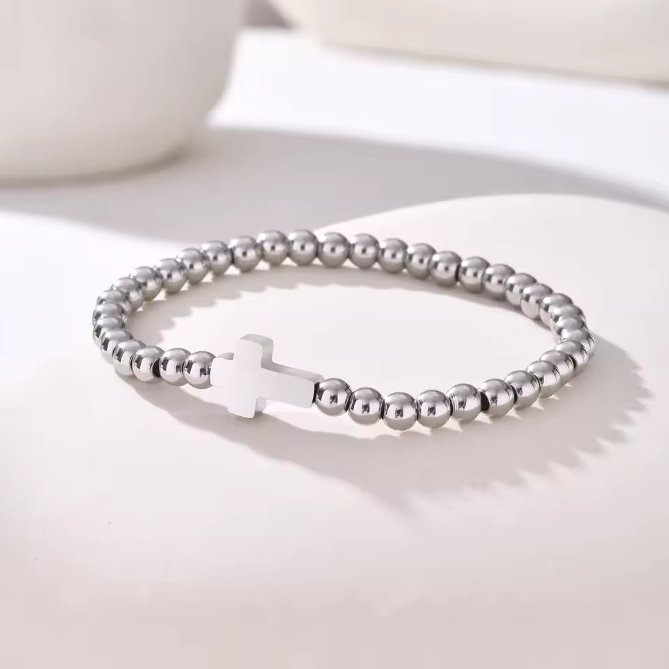 Rooted Bracelet – gold beaded stretch bracelet with minimalist cross charm