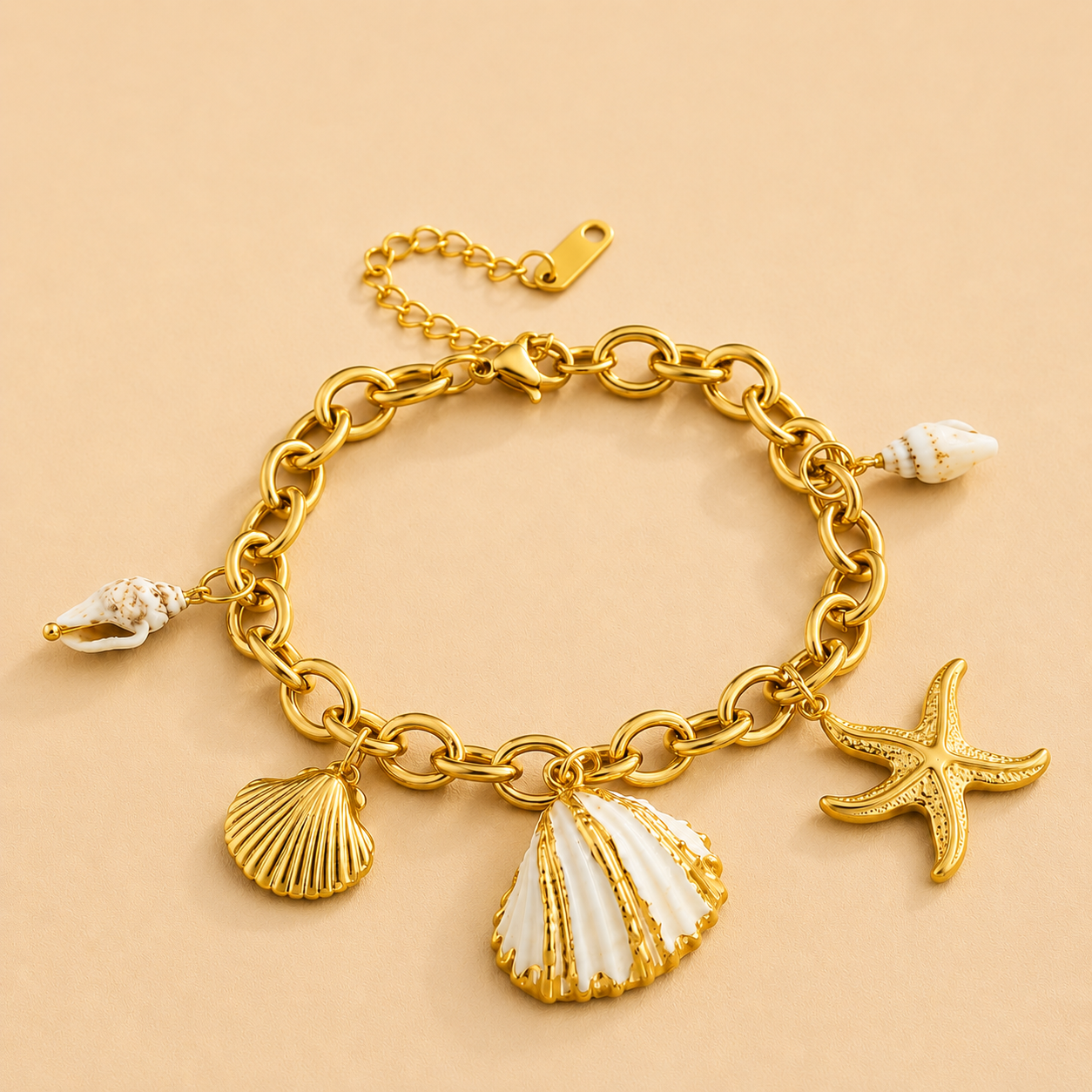 Gold charm bracelet featuring seashell, starfish, and coastal-inspired charms on a chunky chain.