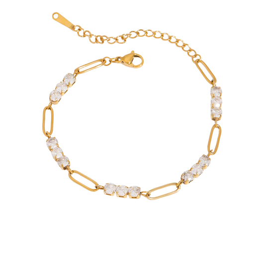 Gold bracelet with clear gemstones on a white background