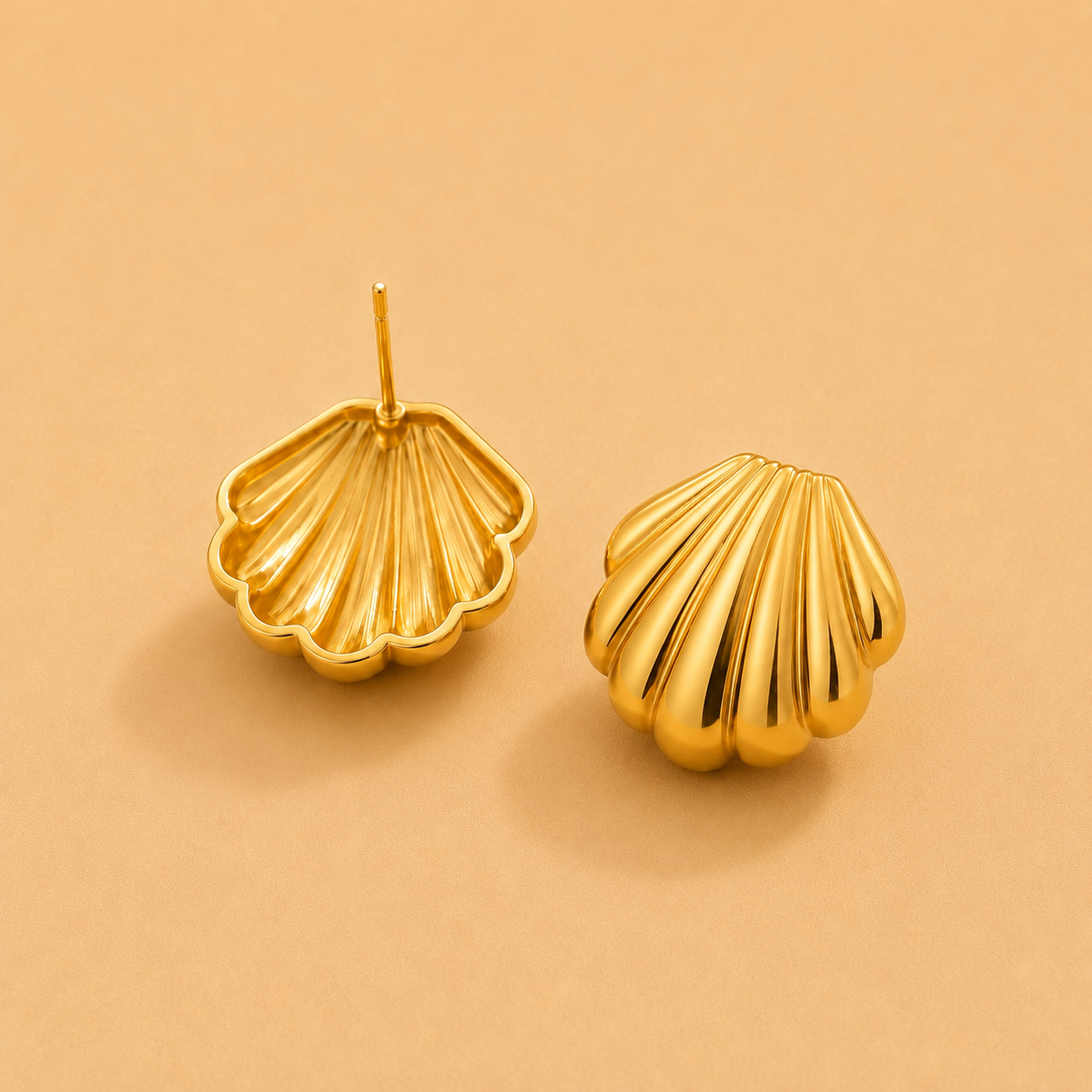 Gold shell stud earrings with a classic seashell design and polished finish.