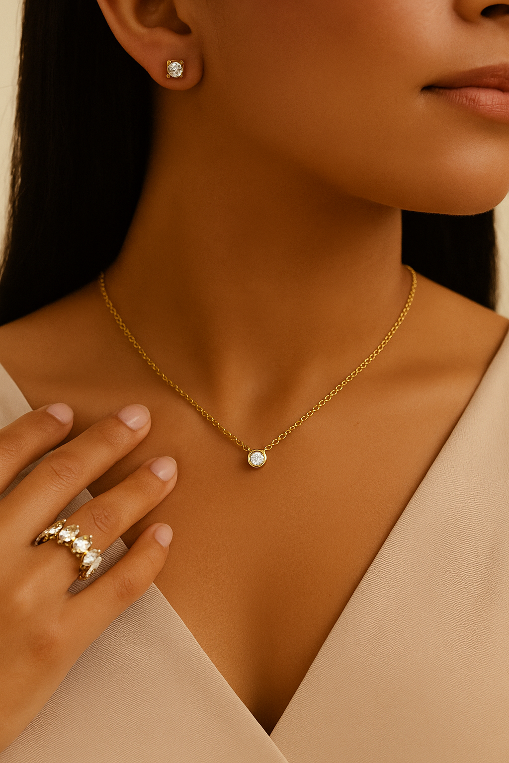 Gold ring with marquise-cut stones styled on fingers, symbolizing royalty and faith and dainty necklace and earrings