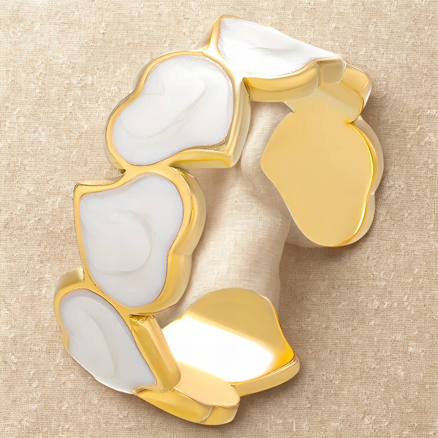 Adjustable gold ring with white enamel heart design.