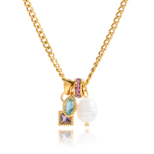 Gold necklace with various charms on a white background