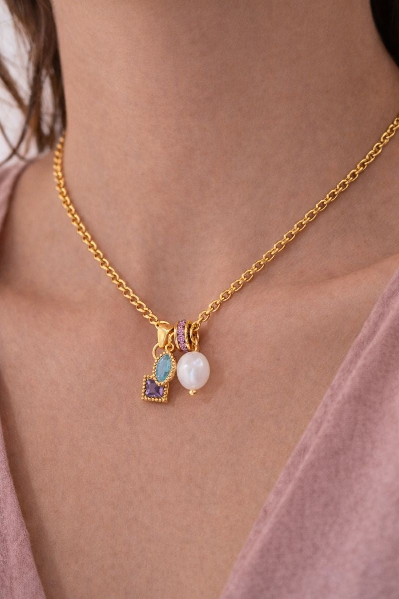Gold Three Kings Charm Necklace featuring pearl and gemstone charms inspired by faith and devotion