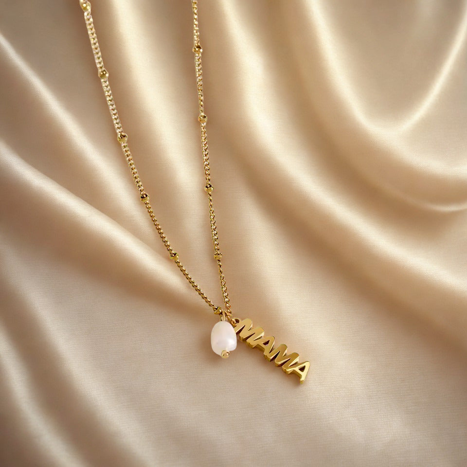 Gold necklace with a pearl pendant on a beige satin background